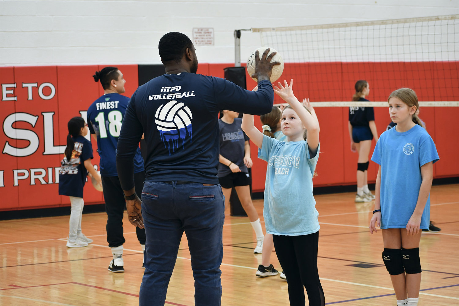 The NYPD men’s and women’s volleyball teams worked with more than 100 children, students of all ages, at the First Responders Volleyball Youth Clinic.
